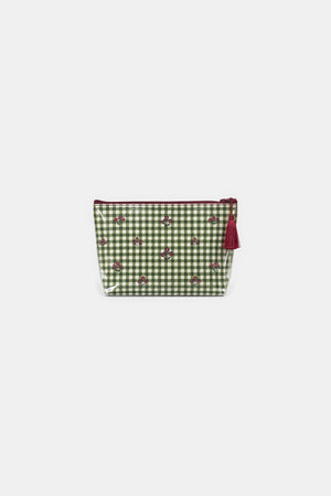 Front view of a zip makeup bag in green and white gingham with small red floral motifs, a clear edge and a red tassel.
