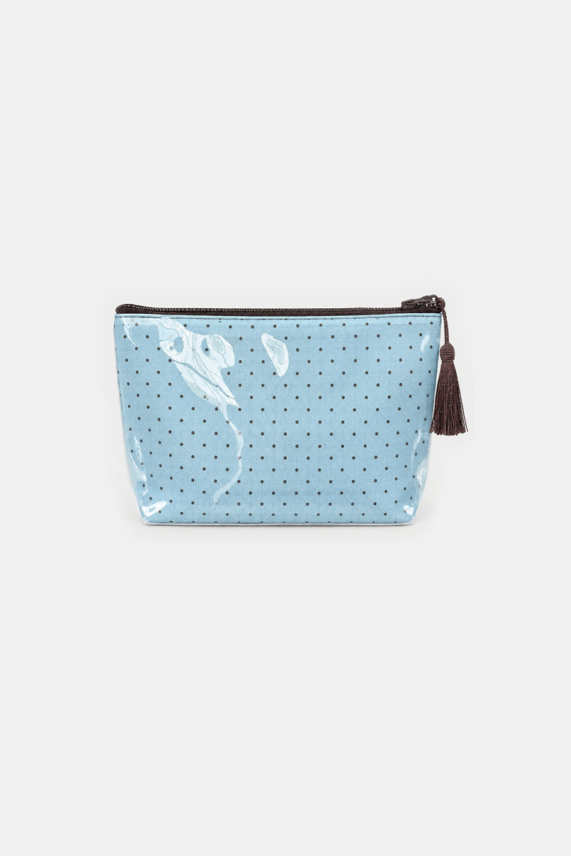 Flat front view of a light blue makeup pouch with small dark dots, a brown top zip and a brown tassel pull, under clear glossy cover.