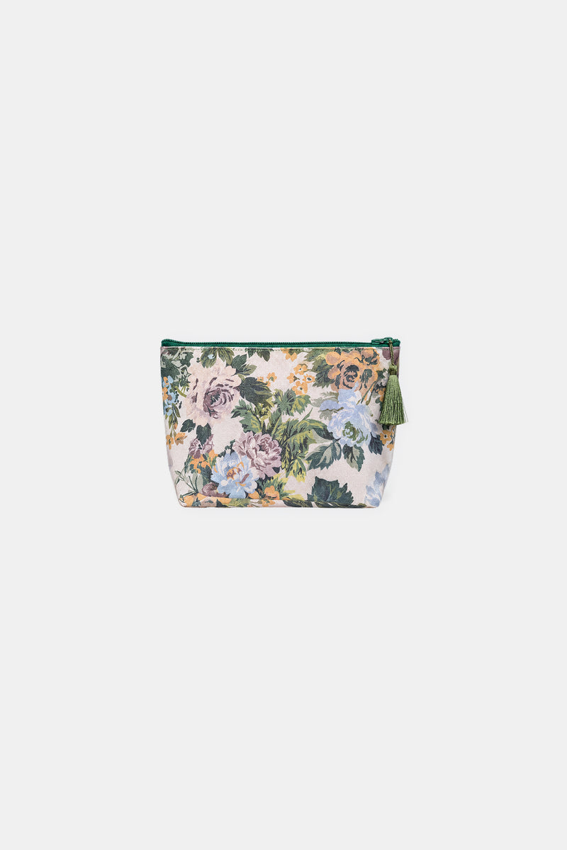 Front view of a small zip-top makeup bag in a cream floral print of pink, blue and yellow flowers, with a green zip and tassel.